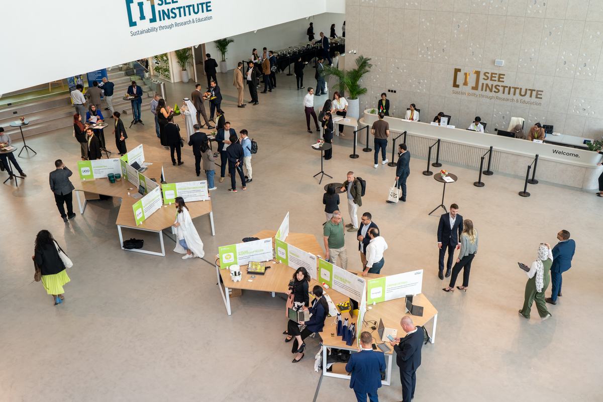 The SEE Institute ground floor with exhibition stands and people moving between them